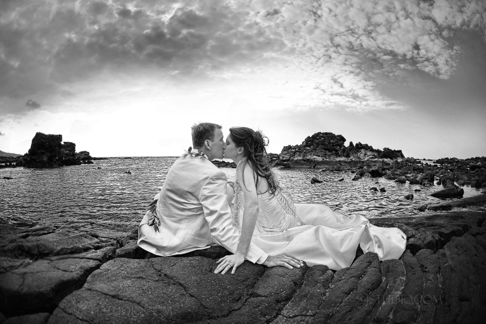 wedding couple kissing black and white on lawa rocks big island hawaii