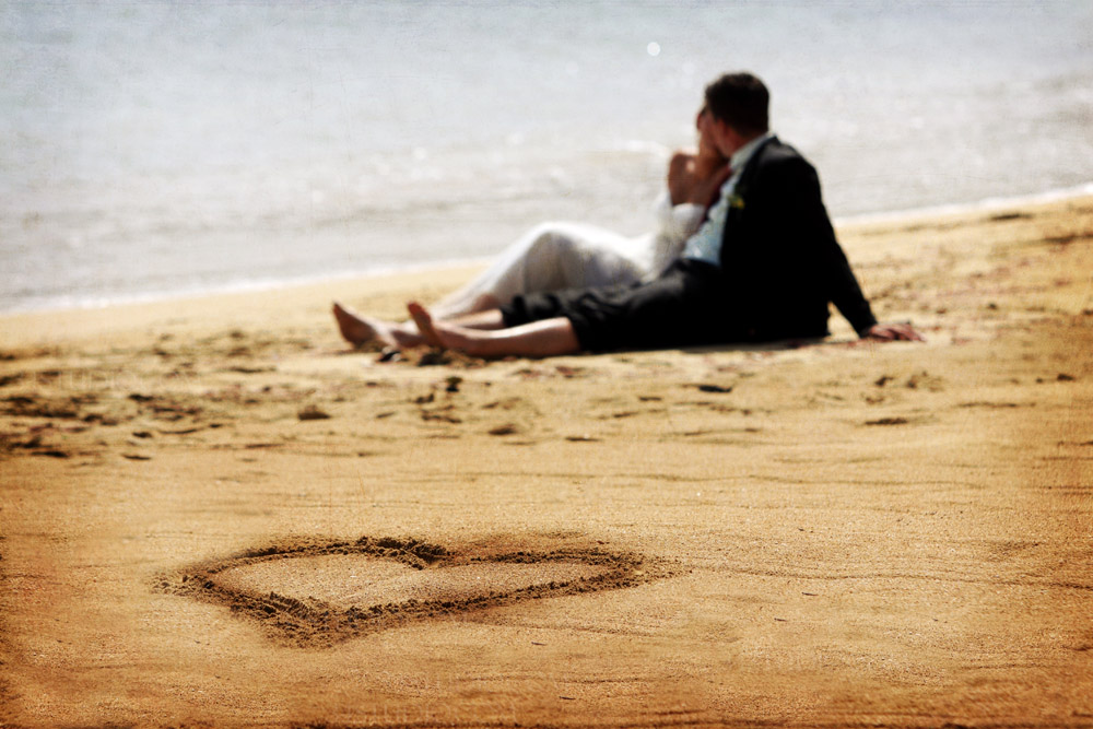 couple is laying by the beach in jamaica ocho rios heart shape sand